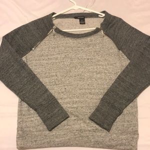 A two toned grey sweater.